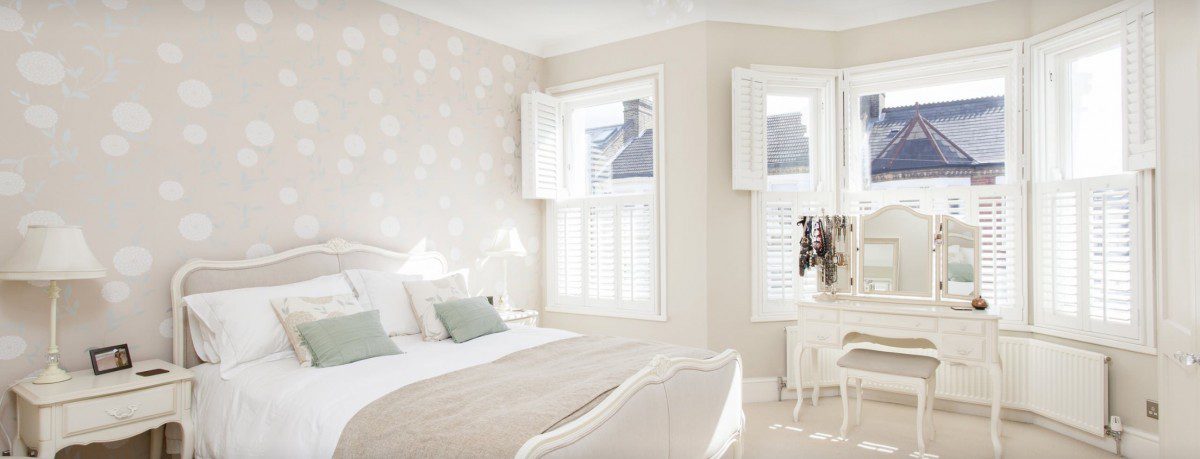 Elegant bedroom completed with wooden shutters