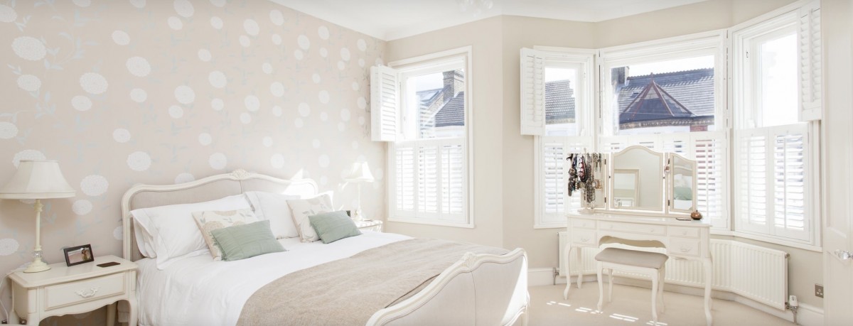 Elegant bedroom completed with wooden shutters